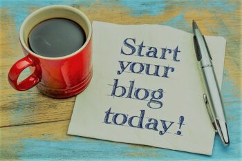 Start your blog today – handwriting on a napkin with a cup of espresso coffee